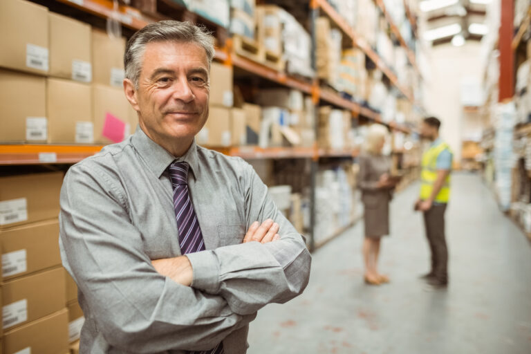 Smiling businessman with crossed arms